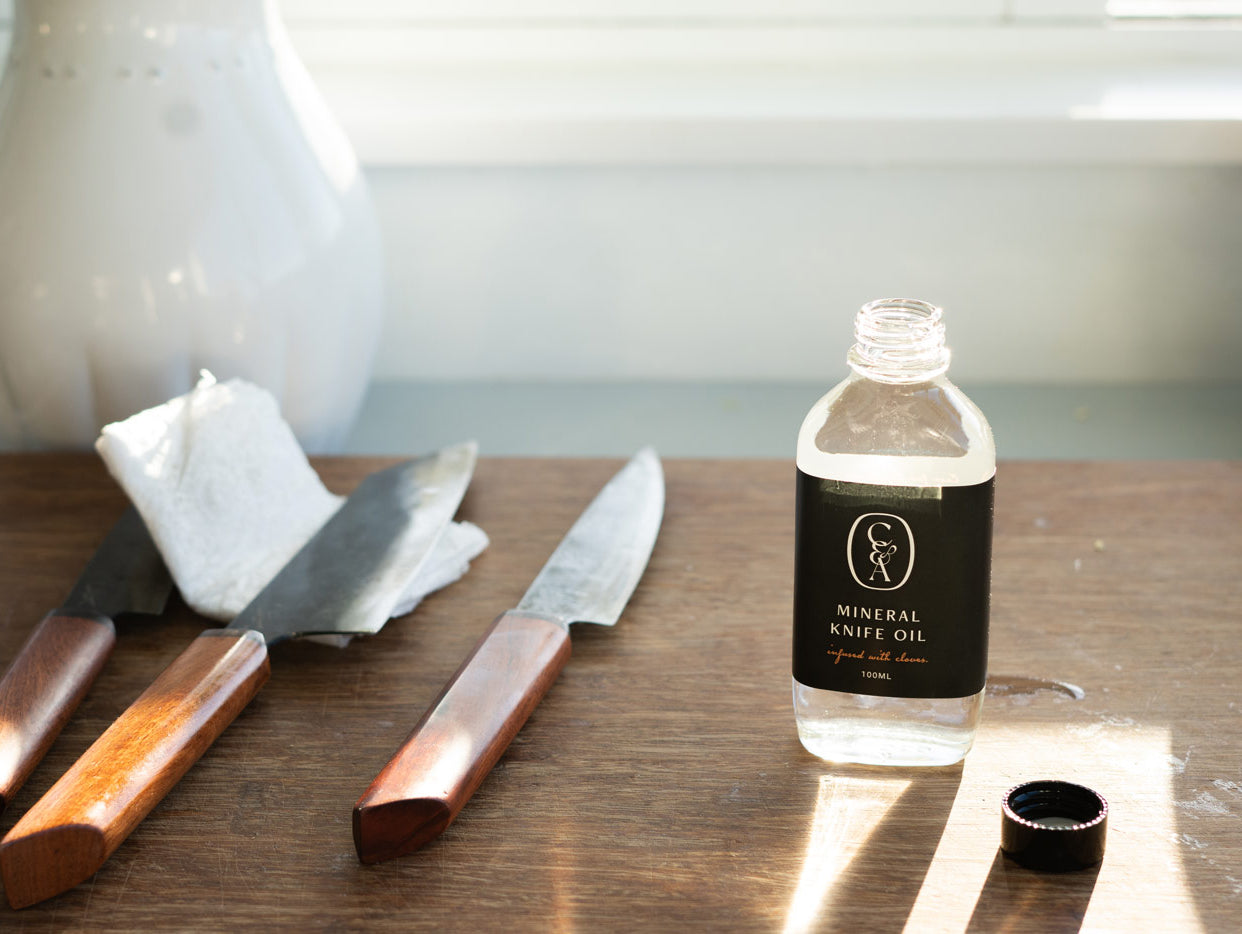 Why is mineral oil important for carbon-steel knives?