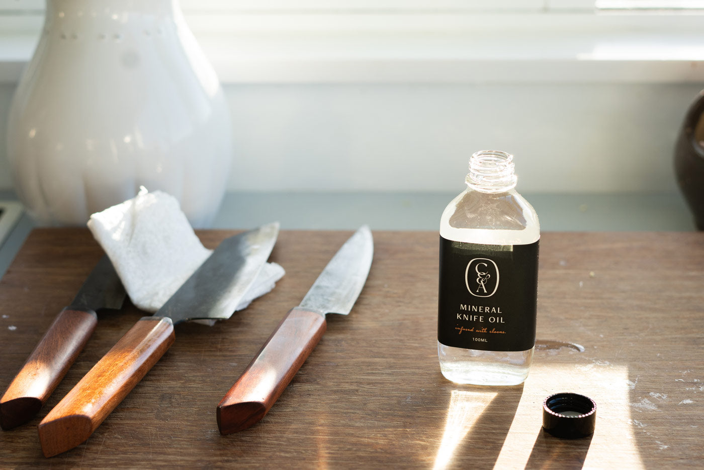 Why is mineral oil important for carbon-steel knives?